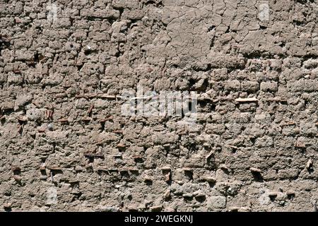 Plastered old clay adobe wall as natural background. Brown stucco ,old wall Stock Photo