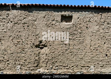 Plastered old clay adobe wall as natural background. Brown stucco ,old wall Stock Photo