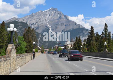 Traffic moving through Banff Avenue with Cascade Mountain in the background. Banff National Park, Alberta, Canada Stock Photo