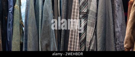 banner or vintage 60s and 70s clothes hanging for sale Stock Photo