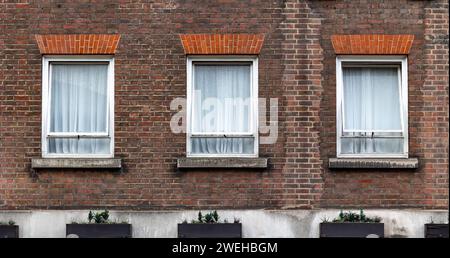 three aligned classic white windows of typical London architecture with ...