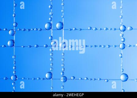 small blue water droplets hanging on fishing line, macro shot Stock Photo