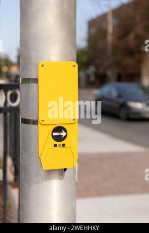 Yellow button for traffic lights for pedestrian at street crossing in the city, Canada Stock Photo