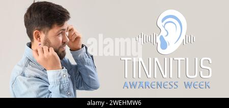 Banner for Tinnitus Awareness Week with young man having hearing disorder Stock Photo