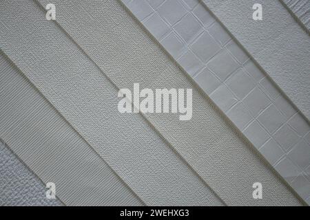 A collection of interior wallpaper samples in textured beige shades. Elite material for wall cladding. Stock Photo