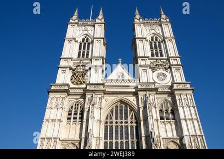 Gothic style architecture stonework of western facade bell towers above Great West Door entrance of Westminster Abbey in central London, England, UK Stock Photo