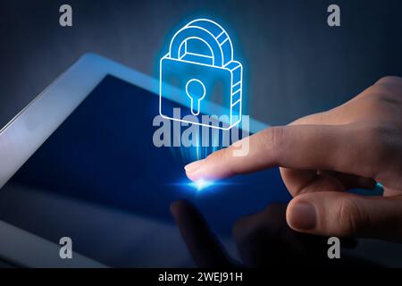 Privacy protection. Woman using tablet, closeup. Illustration of padlock over device Stock Photo