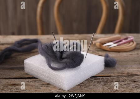 Felting tools and wool on wooden table, closeup Stock Photo