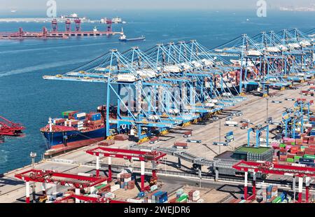 QINGDAO, CHINA - JANUARY 25, 2024 - Container ships enter and exit the ...