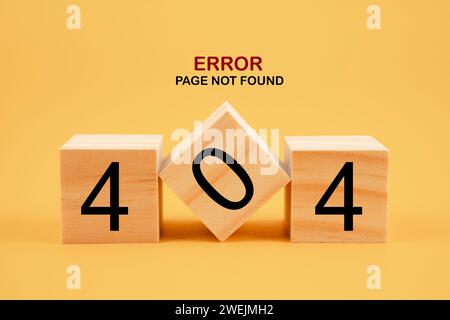 Wooden cubes with 404 error page not found on yellow background. Stock Photo