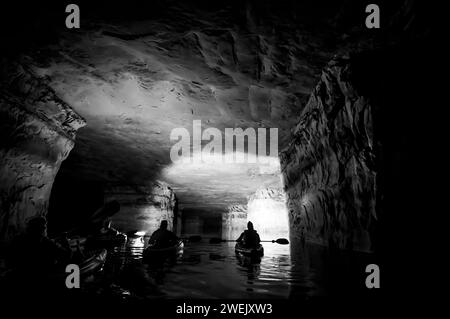 Kayaking a abandoned silica mine that is flooded with water. Stock Photo