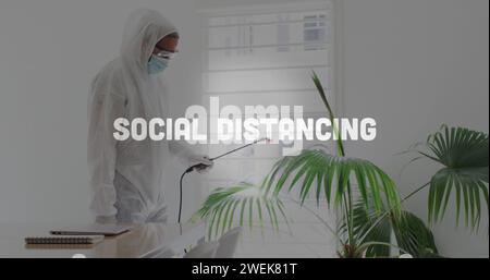 Image of flashing words with man disinfecting the office Stock Photo