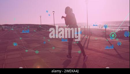 Network of connections against african american male boxer practicing boxing walking on promenade Stock Photo