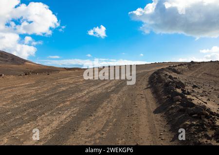 Dirt road in a volcanic landscape in Los Ajaches National Park near Papagayo beach. Playa Blanca, Lanzarote, Spain Stock Photo