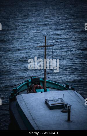 A boat sailing on tranquil waters at night Stock Photo