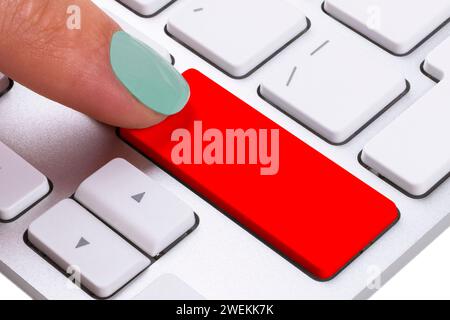 Close up view of a Finger Pushing on a red Button of computer Keyboard. Finger Pressing a Slim Aluminum Keyboard Button. Empty space for text Stock Photo