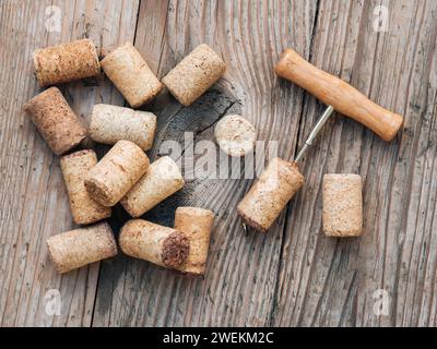 Top view of wine corks and corkscrew on old wooden unpainted table. Stock Photo