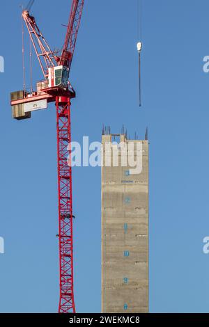 Portrait image of the concrete core tower & tower crane on a sunny day during construction of One Victoria residential development in Manchester, UK Stock Photo