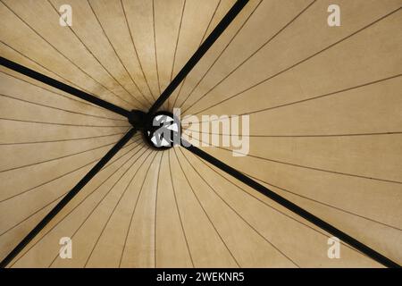 Bottom top view of a tensile canopy structure from under the roof Stock Photo