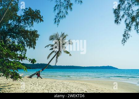 Beautiful beach with palms and turquoise sea in Koh Kood island, Thailand. Tropical sea beach with sand and coconut tree clear blue sky background. Su Stock Photo