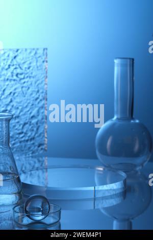 Lab theme. Science and medical background with laboratory glass - boiling flask, erlenmeyer flask and petri dish on blue background. Round transparent Stock Photo