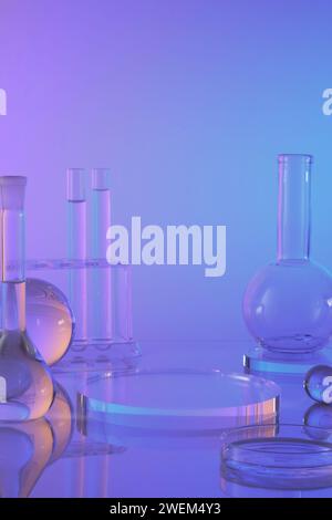 Background of scientific glassware for chemical and round transparent podium decorated on blue background. Lab theme. Science and medical background, Stock Photo