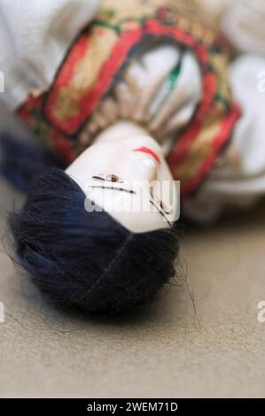 Doll lying down on floor Stock Photo