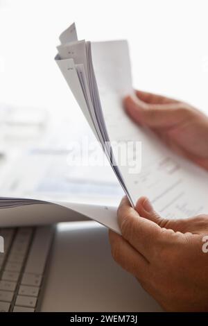 Man's Hands Sorting Out Bills and Documents Stock Photo