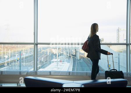 Back view of a woman at train station terminal Stock Photo