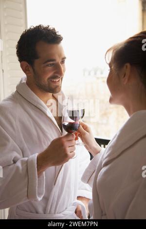 Couple toasting each other with red wine Stock Photo