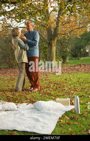 Senior couple dancing in a park Stock Photo
