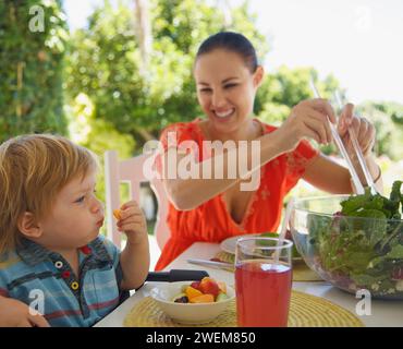 Woman and Child Eating Outside Stock Photo