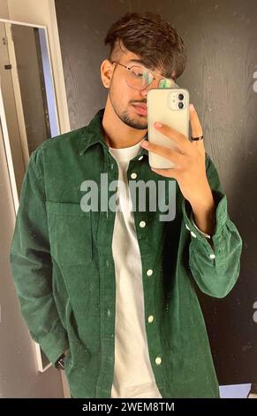 Young man taking a mirror selfie Stock Photo