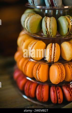 Cropped view of a tower of colorful macarons on dark background Stock Photo