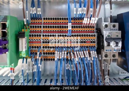 Multiple wires plugged into electronic terminal junction Stock Photo