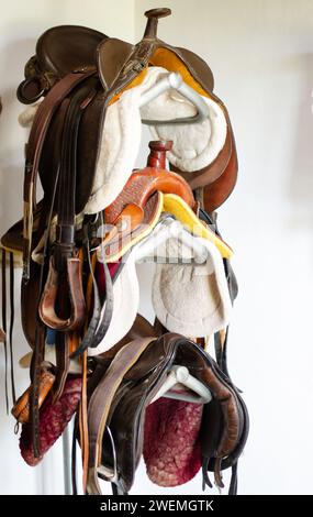 Room with stacked multicolor saddles Stock Photo