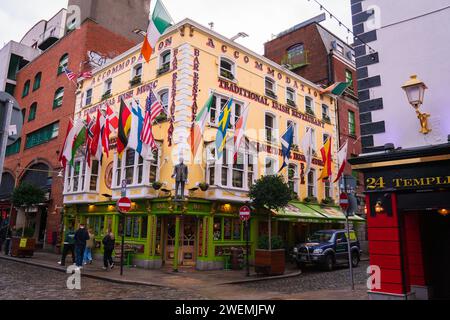 The Oliver St. John Gogarty bar and restaurant in the temple bar district of Dublin, Ireland, in winter. Colorful flags, green and beige exterior. Stock Photo
