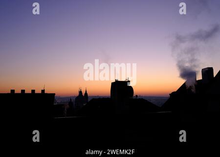 Early morning as the sun rises over Prague, with smoke from a house chimney Stock Photo