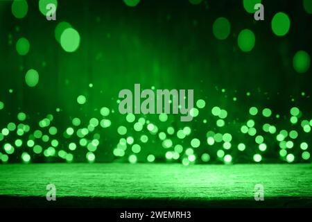 Happy St. Patricks Day background. Abstract green background with empty wooden table and glitter lights background. St. Patricks Day holidays wallpape Stock Photo