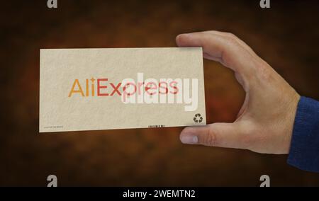 Poznan, Poland, January 25, 2024: AliExpress Alibaba group online retail box in hand. E-business chinese company. Cardboard pack factory. Abstract con Stock Photo