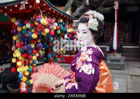 Beautiful Japanese Geisha Maiko in Kyoto, Japan with umbrella Stock Photo