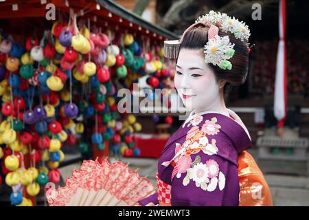 Beautiful Japanese Geisha Maiko in Kyoto, Japan with umbrella Stock Photo