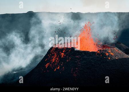 A powerful eruption of the Piton de la Fournaise volcano on Reunion Island, as molten lava forcefully shoots up into the sky. Stock Photo