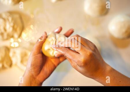 Close up hands preparing dough for pizza Stock Photo