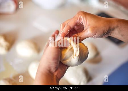 Close up hands preparing dough for pizza Stock Photo