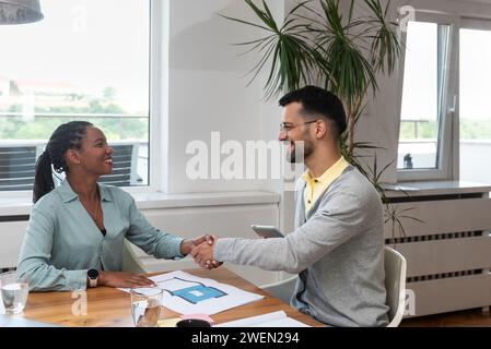 Two young business people interior and exterior designers architects of prefab ecological houses working at home office on a project of energy efficie Stock Photo