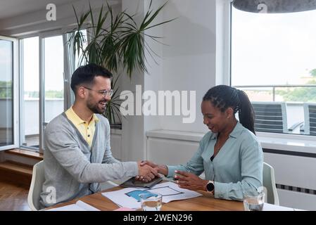 Two young business people interior and exterior designers architects of prefab ecological houses working at home office on a project of energy efficie Stock Photo