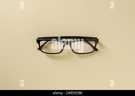 Prescription glasses with black frames on a yellow background Stock Photo