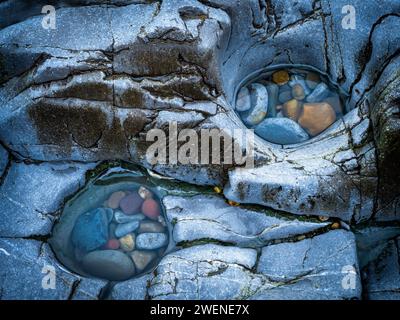 Pebbles in two pools in the rocks of Bracelet Bay. Stock Photo