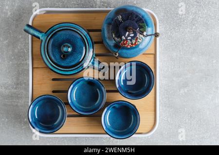 Blue tea set teapot with cups on a gray concrete background Stock Photo